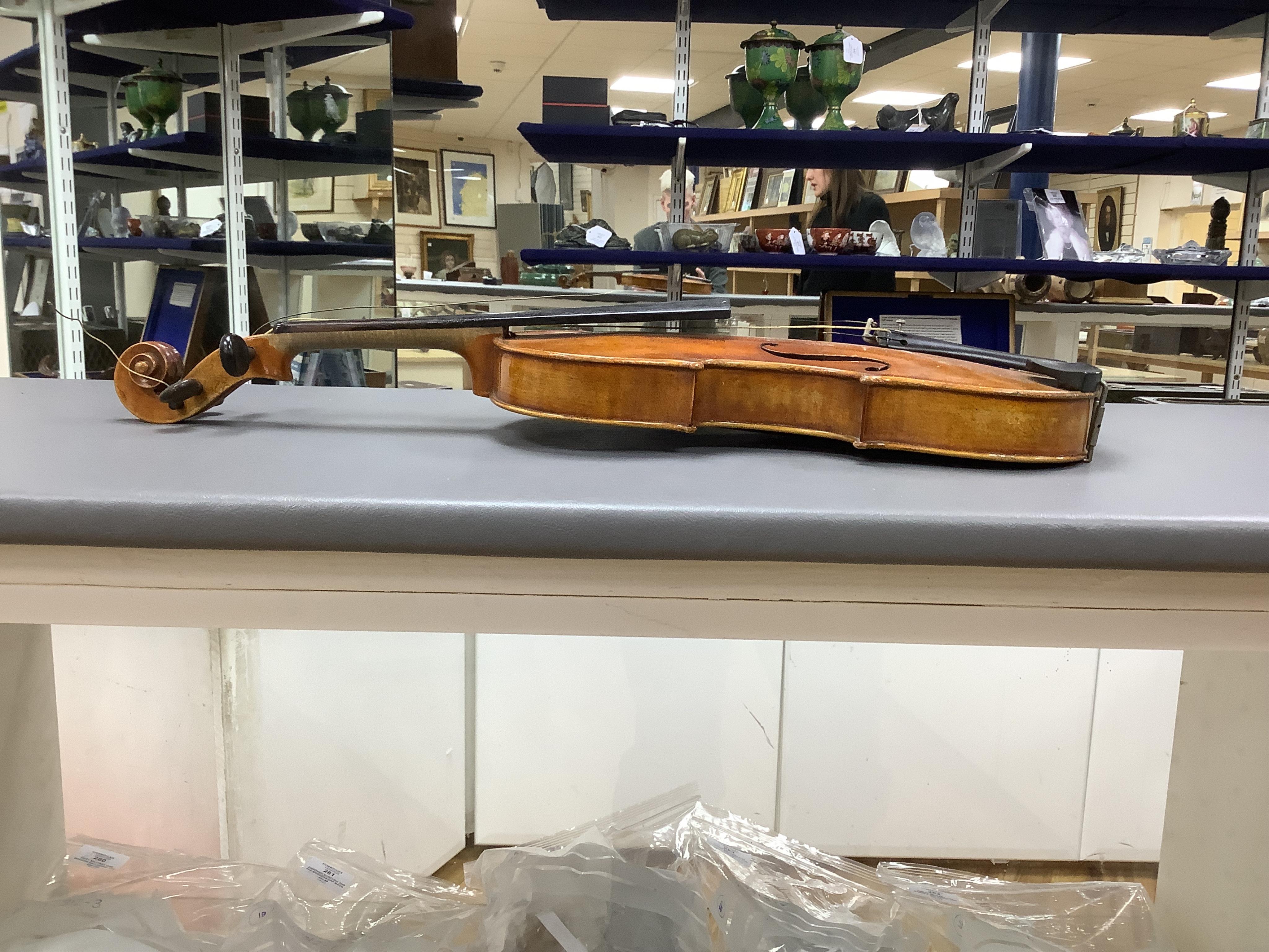 A cased full length violin, circa 1900, with bow, bears Stradivarius label to the interior. CITES Submission reference WVME8714